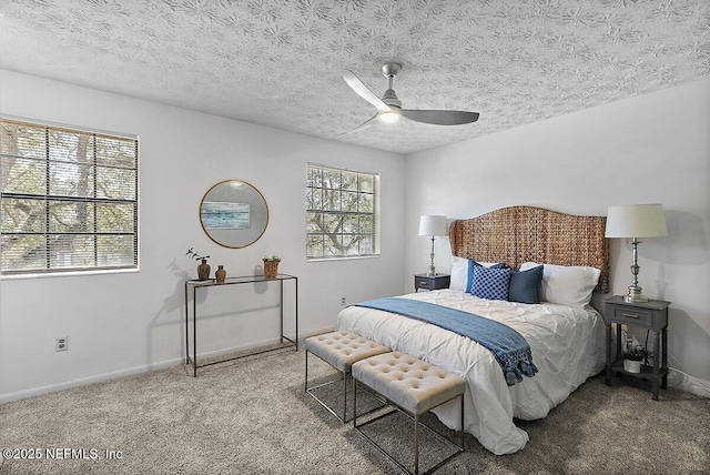 bedroom with ceiling fan, a textured ceiling, baseboards, and carpet flooring