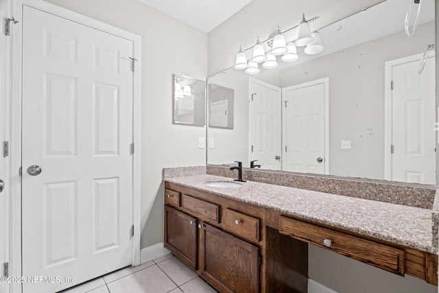 bathroom featuring tile patterned flooring and vanity