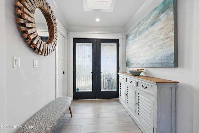 entrance foyer featuring light wood-style floors, recessed lighting, and french doors