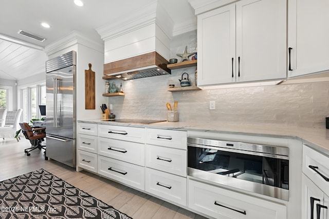 kitchen with open shelves, appliances with stainless steel finishes, and white cabinetry