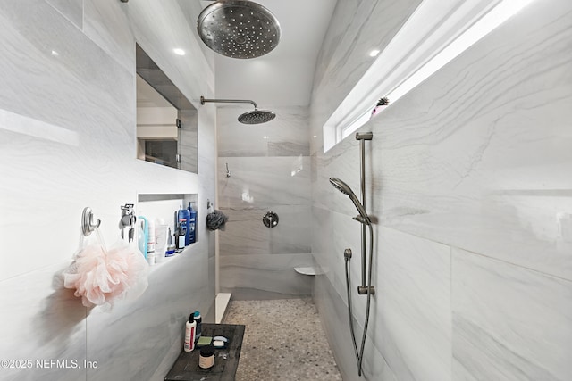 full bathroom featuring speckled floor and a marble finish shower