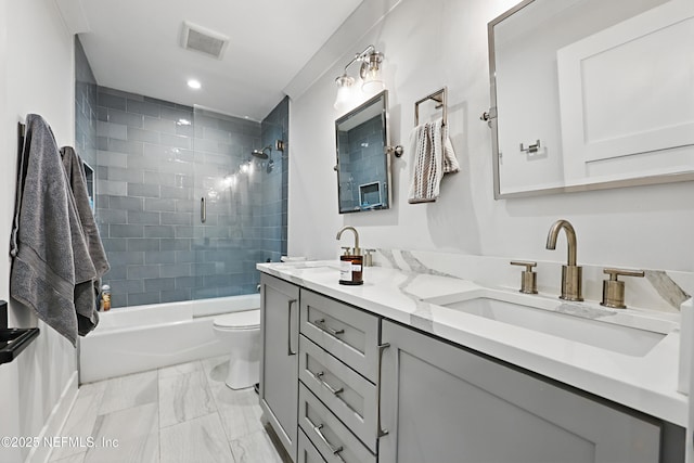 bathroom featuring visible vents, toilet, marble finish floor, a sink, and shower / bathing tub combination