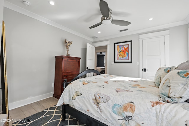 bedroom with light wood finished floors, recessed lighting, visible vents, ornamental molding, and baseboards