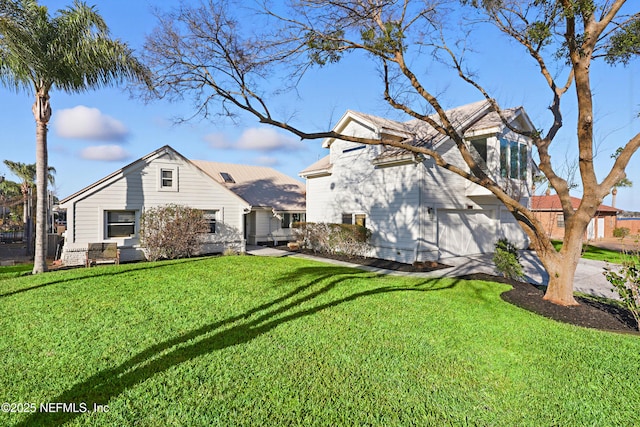 exterior space with a garage, a yard, and concrete driveway