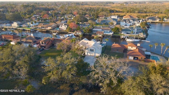 birds eye view of property with a water view and a residential view