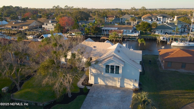 drone / aerial view featuring a residential view and a water view