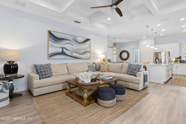 living room with coffered ceiling, light wood-type flooring, visible vents, and beamed ceiling