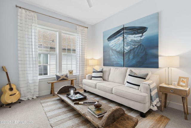 living area featuring carpet and baseboards