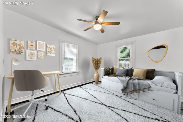 bedroom with vaulted ceiling, baseboards, and ceiling fan