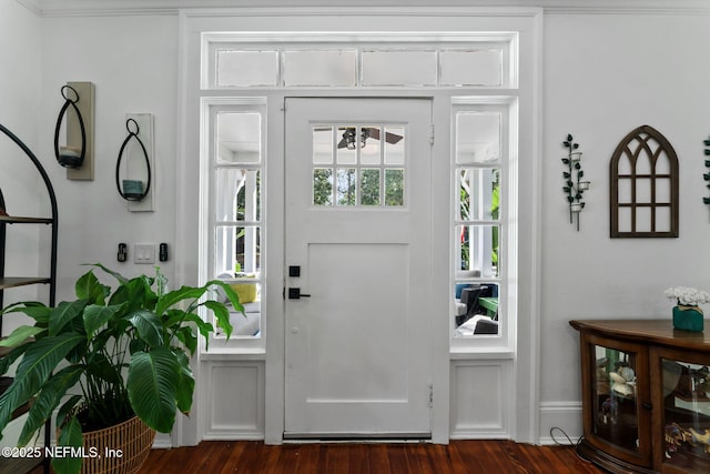 entrance foyer with dark wood-style flooring and baseboards