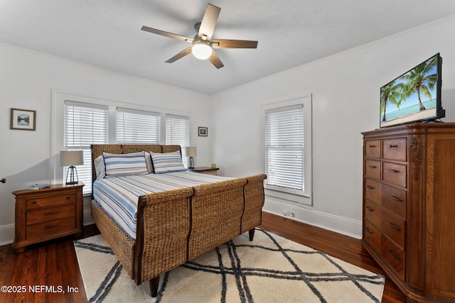 bedroom featuring dark wood-type flooring, ceiling fan, and baseboards