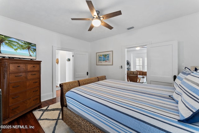 bedroom featuring dark wood-type flooring, visible vents, and ceiling fan