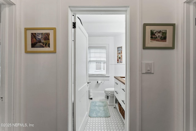 bathroom featuring toilet, vanity, and tile patterned floors