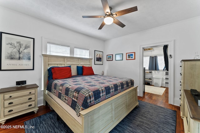 bedroom with ceiling fan, baseboards, dark wood finished floors, and a textured ceiling