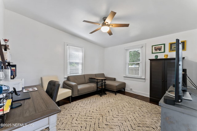 home office featuring vaulted ceiling, dark wood-style flooring, plenty of natural light, and ceiling fan