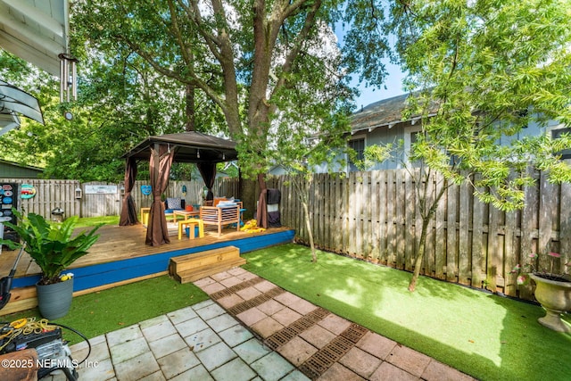 view of yard featuring an outdoor hangout area, a gazebo, a fenced backyard, and a wooden deck