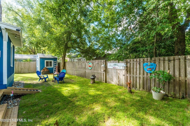 view of yard featuring a fenced backyard and an outdoor structure