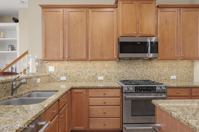 kitchen with a sink, light stone countertops, backsplash, and stainless steel appliances