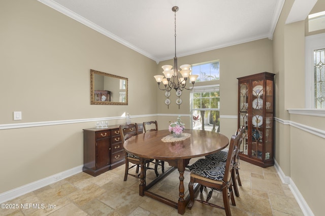 dining room with an inviting chandelier, stone finish flooring, baseboards, and ornamental molding