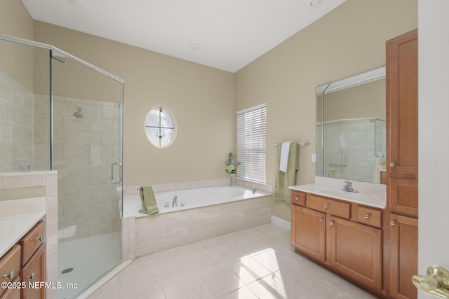 bathroom featuring a bath, a shower stall, tile patterned floors, and vanity