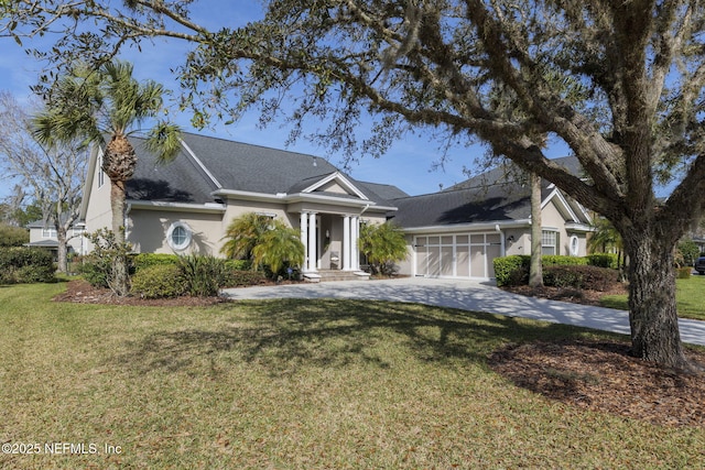 view of front of property featuring stucco siding, a front lawn, concrete driveway, and an attached garage