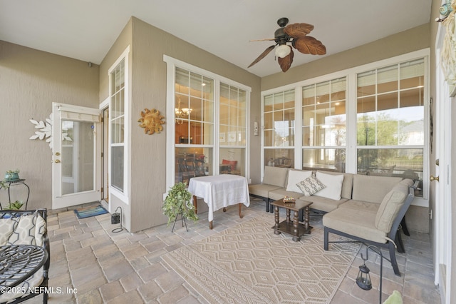 sunroom featuring a ceiling fan