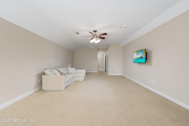 unfurnished living room featuring visible vents, ceiling fan, baseboards, lofted ceiling, and light carpet