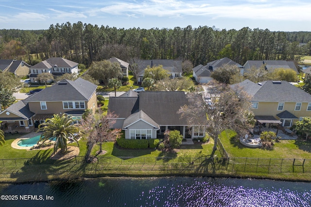 birds eye view of property with a residential view and a water view