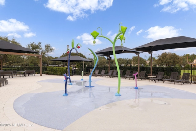 view of jungle gym with a patio area and fence