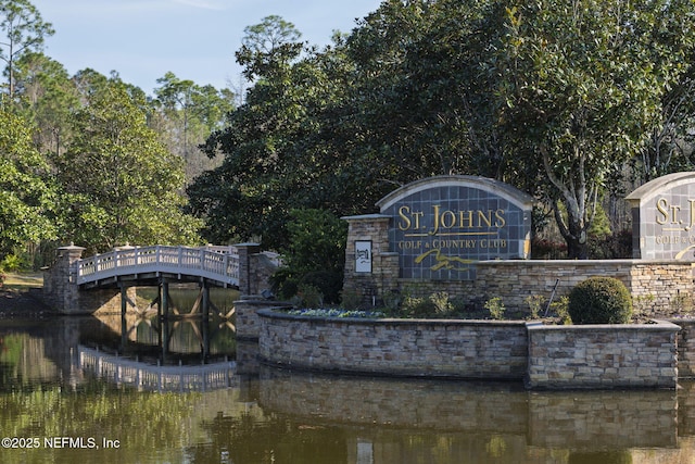 community / neighborhood sign with a water view