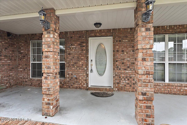 property entrance featuring brick siding