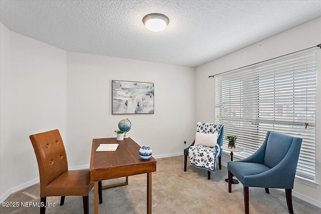 carpeted home office featuring a textured ceiling and baseboards