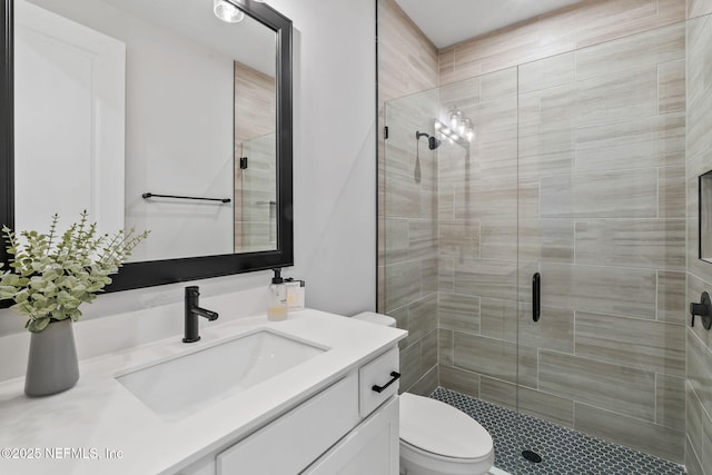 full bath featuring a shower stall, toilet, and vanity