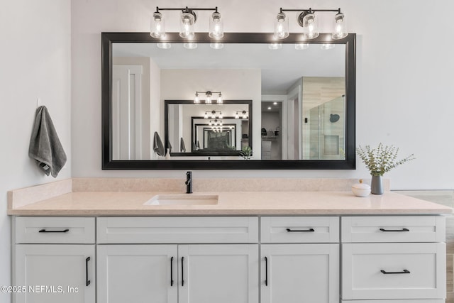 bathroom with a shower stall and vanity