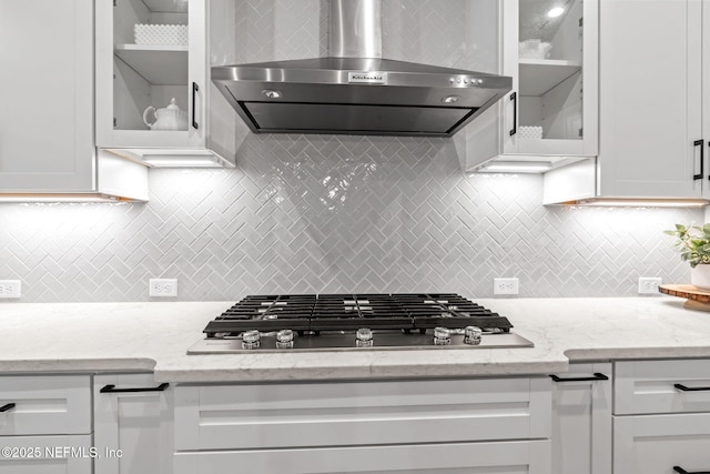 kitchen with white cabinetry, stainless steel gas cooktop, and wall chimney exhaust hood