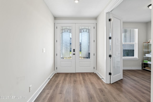 entrance foyer featuring french doors, wood finished floors, and baseboards