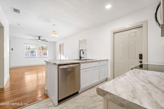 kitchen featuring visible vents, dishwasher, hanging light fixtures, white cabinetry, and a sink