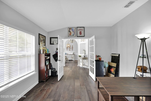 office space with arched walkways, lofted ceiling, visible vents, french doors, and dark wood-style floors