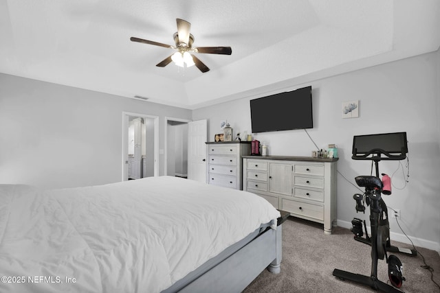 bedroom with light colored carpet, a ceiling fan, baseboards, visible vents, and a raised ceiling