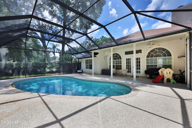 outdoor pool with a lanai, a patio, french doors, and ceiling fan