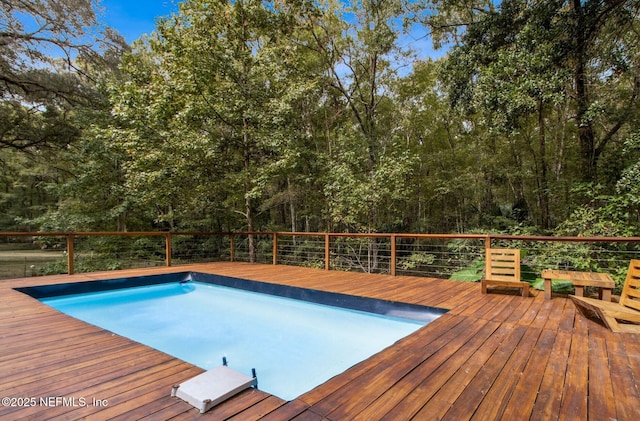 view of swimming pool featuring a wooden deck