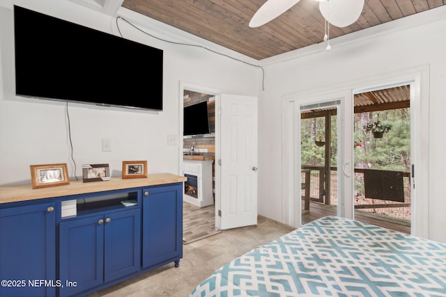 bedroom with wood ceiling, access to outside, and a sink