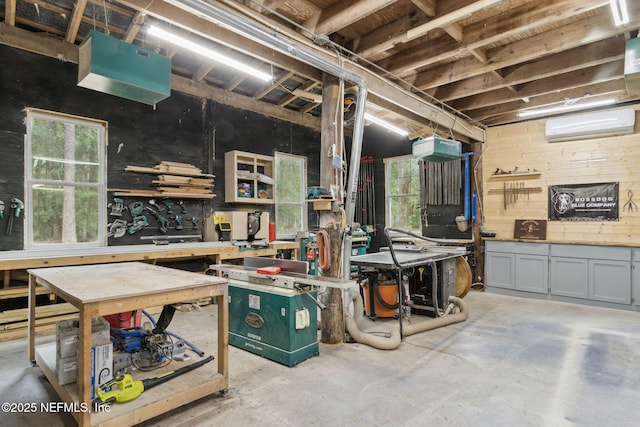 basement with a wall mounted AC and a workshop area