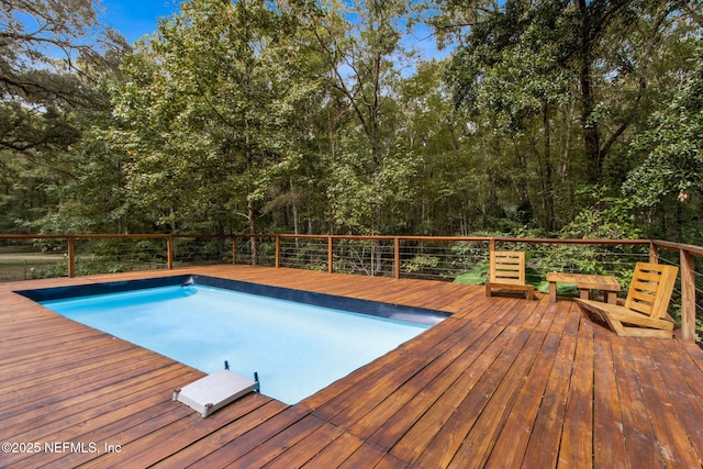 view of swimming pool with a wooden deck