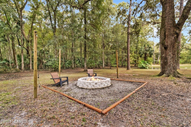 view of yard with an outdoor fire pit