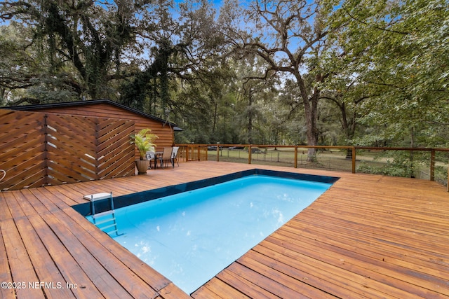 view of swimming pool with a deck and a fenced in pool