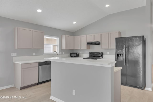 kitchen featuring lofted ceiling, under cabinet range hood, a kitchen island, light countertops, and black appliances