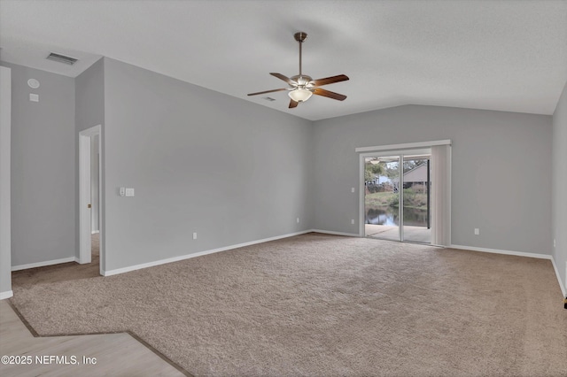 unfurnished living room with ceiling fan, light carpet, visible vents, baseboards, and vaulted ceiling