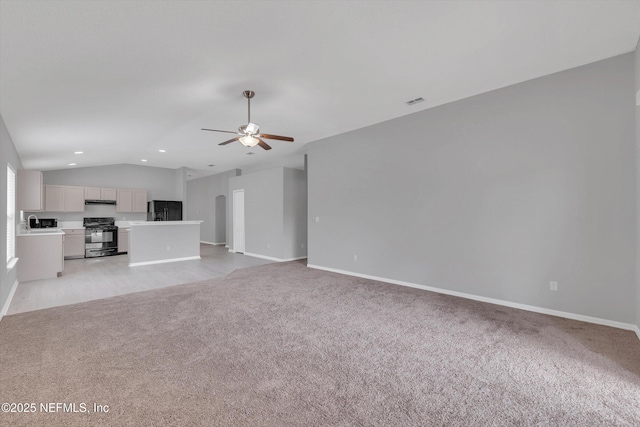 unfurnished living room with lofted ceiling, baseboards, a ceiling fan, and light colored carpet