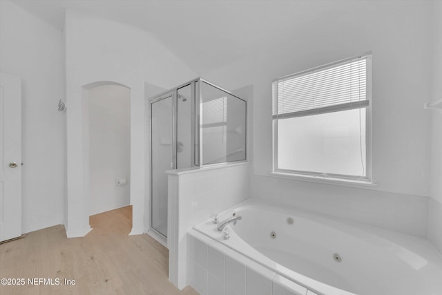 full bathroom featuring a stall shower, plenty of natural light, and a jetted tub